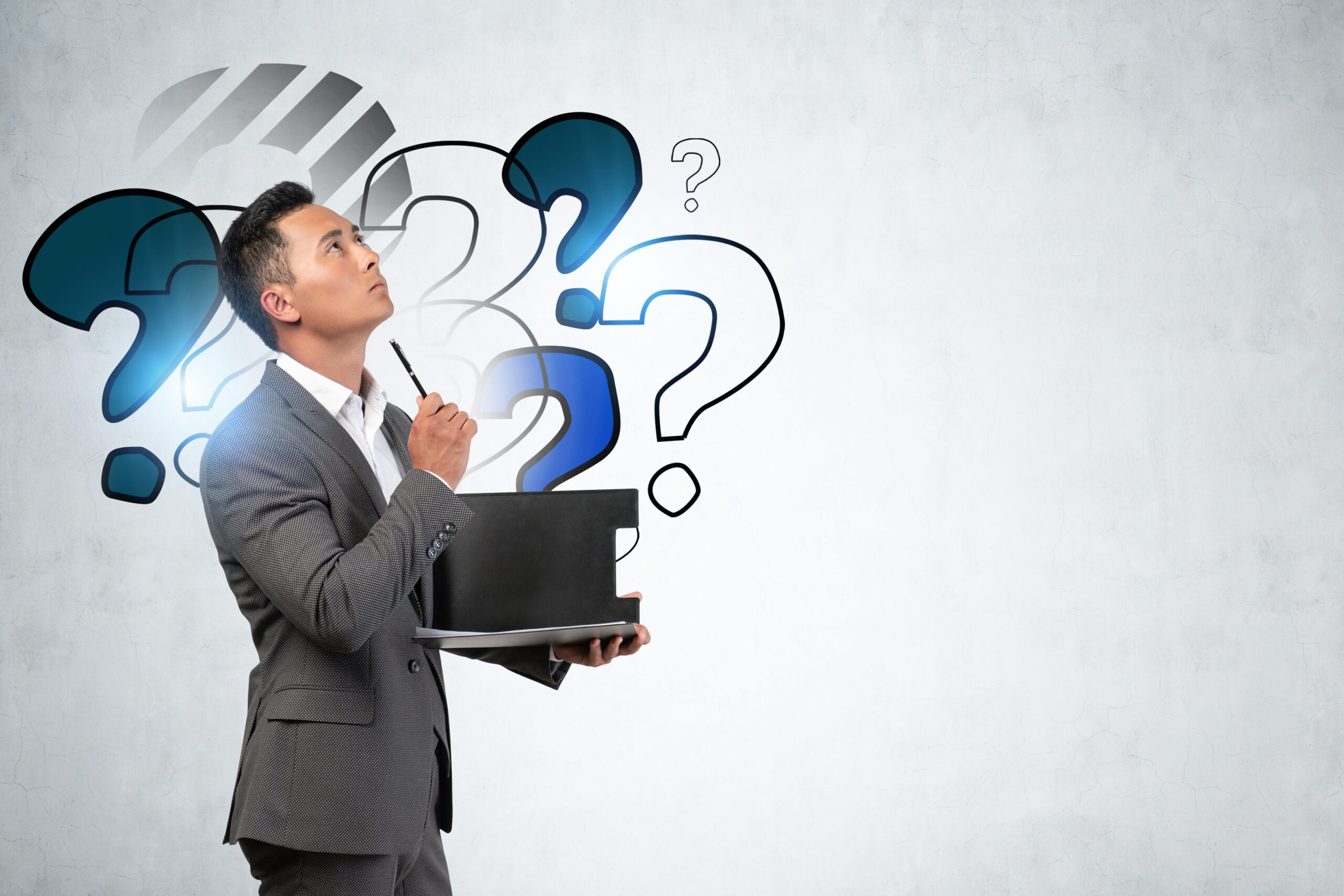 Sales recruiter surrounded by question marks, considering important hiring questions and insights.
